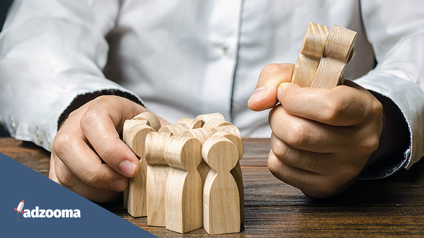 A person holding wooden meeples