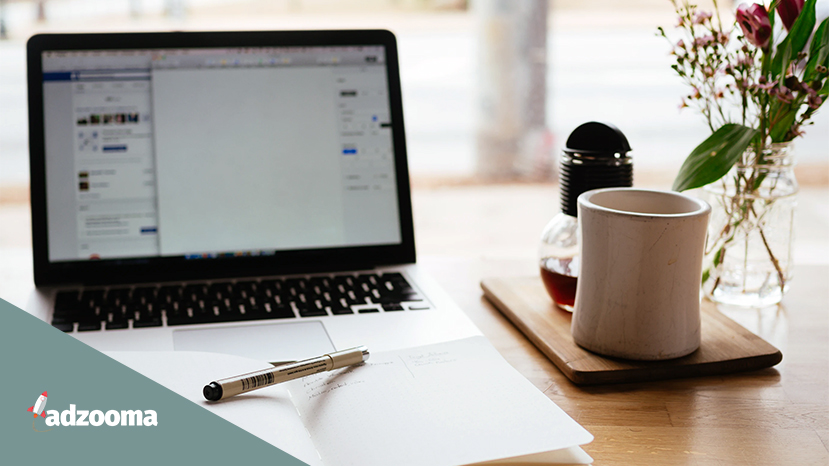 A notebook and laptop on a desk