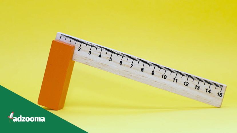 A wooden ruler on a yellow background